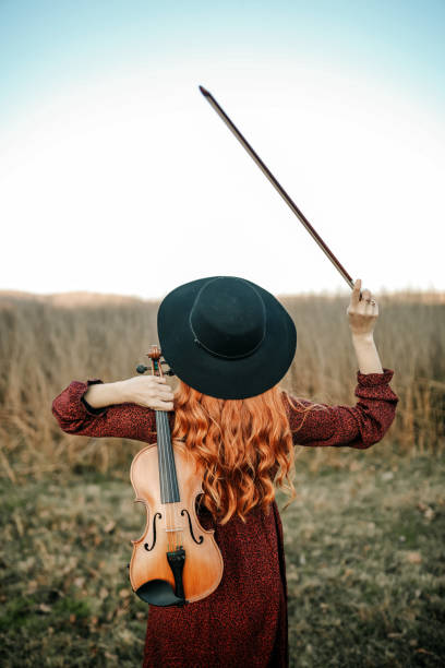 istock Musical instrument, Violin And Red-Haired Woman 1358605437