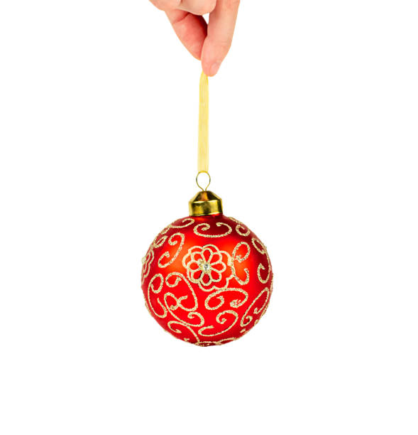 istock Glass Ball in Hand on White Background Christmas Tree Toy. Isolate 1358606691