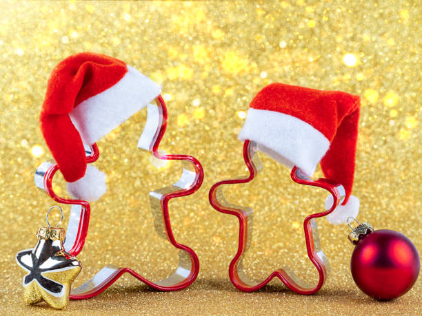 istock Gingerbread men in a Santa hat on a gold background with bokeh 1358606747
