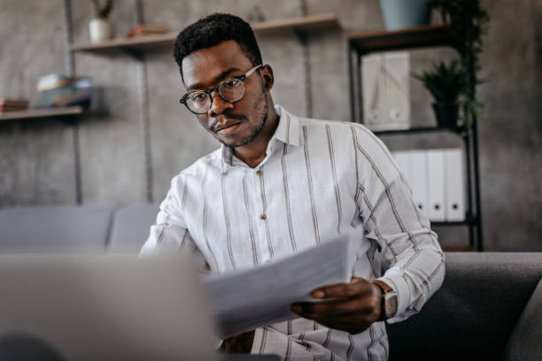 istock Young men working on laptop with finances 1358607771