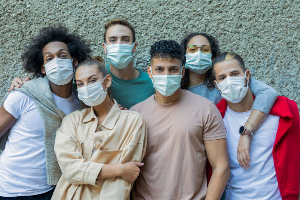 istock Multiracial young people wearing protective masks 1358609031