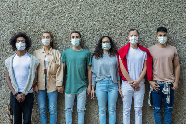 istock Multiracial young people wearing protective masks 1358609134