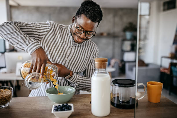 istock Men preparing breakfast in kitchen at home 1358609372