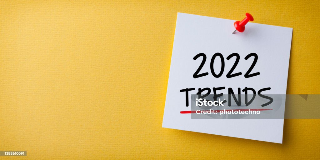 Trends 2022 Word in Yellow Sticky Note on Yellow Background 2022 Stock Photo