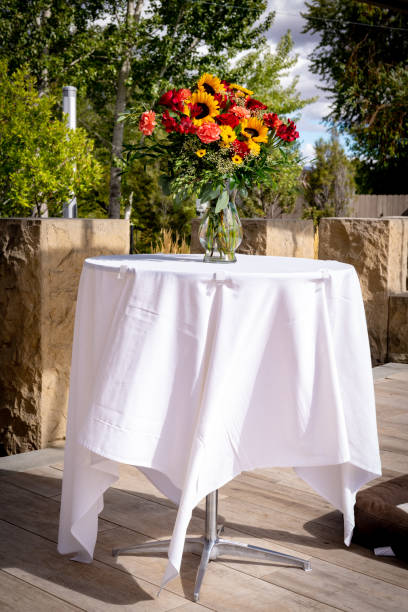 istock Vase of fresh flowers on a white tablecloth table 1358610286