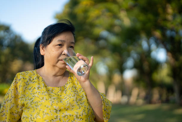 istock Senior woman drinking water 1358610306