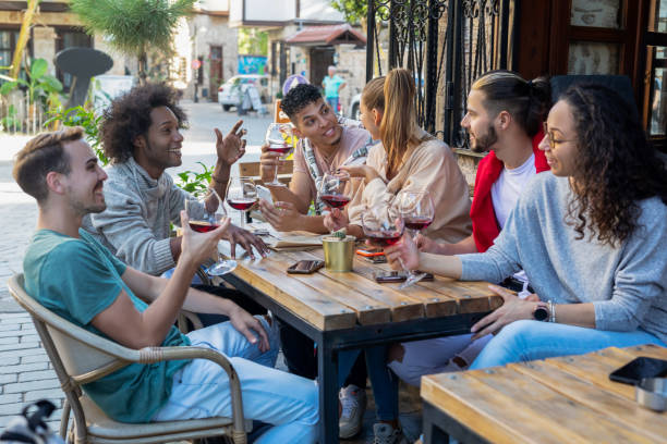 istock Happy friends drinking wine and laughing together 1358611611