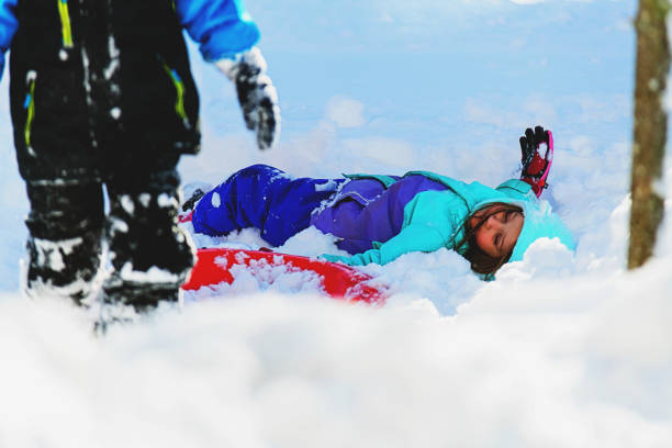 istock Brother & Sister Sledding 1358612753