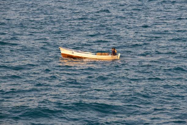 fishing boat at sea - fishing nautical vessel small men imagens e fotografias de stock