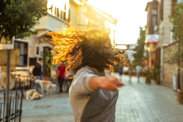 Happy woman dancing in city