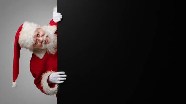 istock Santa Claus with black billboard 1358613020