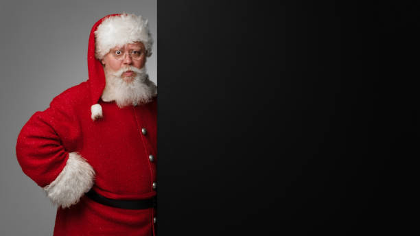 istock Santa Claus with black billboard 1358613028
