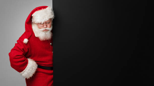 istock Santa Claus with black billboard 1358613037