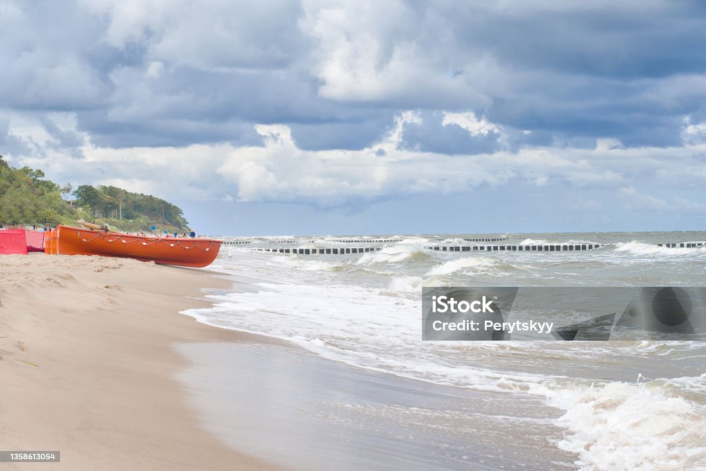 wooden fishing boat wooden fishing boat on the beach in Poland. Baltic Sea Beach Stock Photo