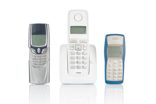 istock Old used wireless and mobile phones isolated on white background 1358613133