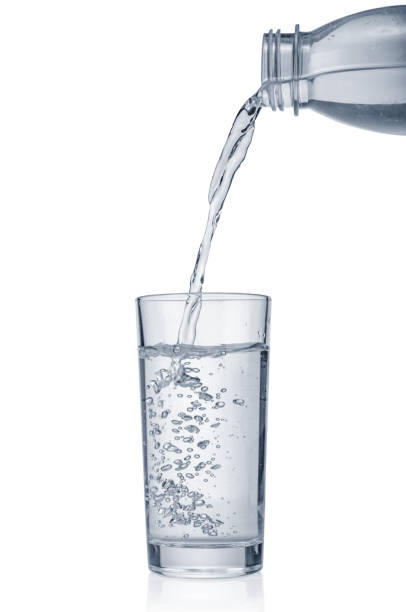 istock Flowing pure water into glass isolated on white background 1358613912