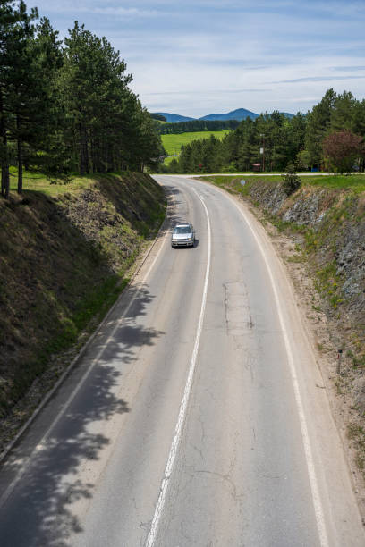 istock The car is driving on a mountain road 1358614440