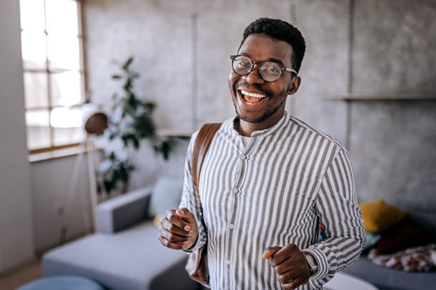 istock Cheerful young man with backpack at home 1358615320