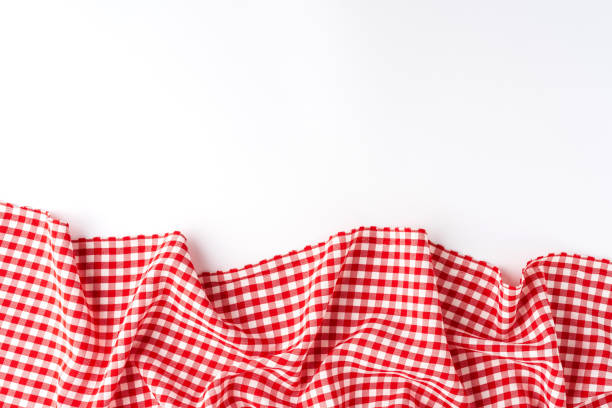 Gingham cloth on white background with copyspace. Top view stock photo