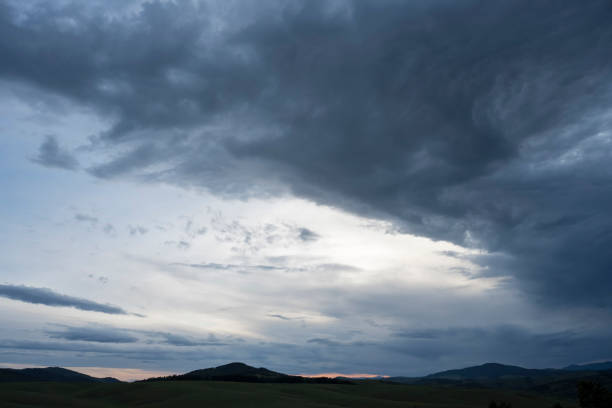 Cloudy sky covering mountain or hill.