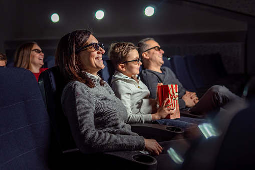 Family enjoying a movie in the cinema