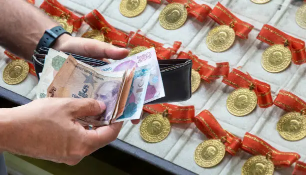 male hand taking money out of wallet in jewelery shop