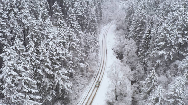 istock Car driving on winter country road 1358621900