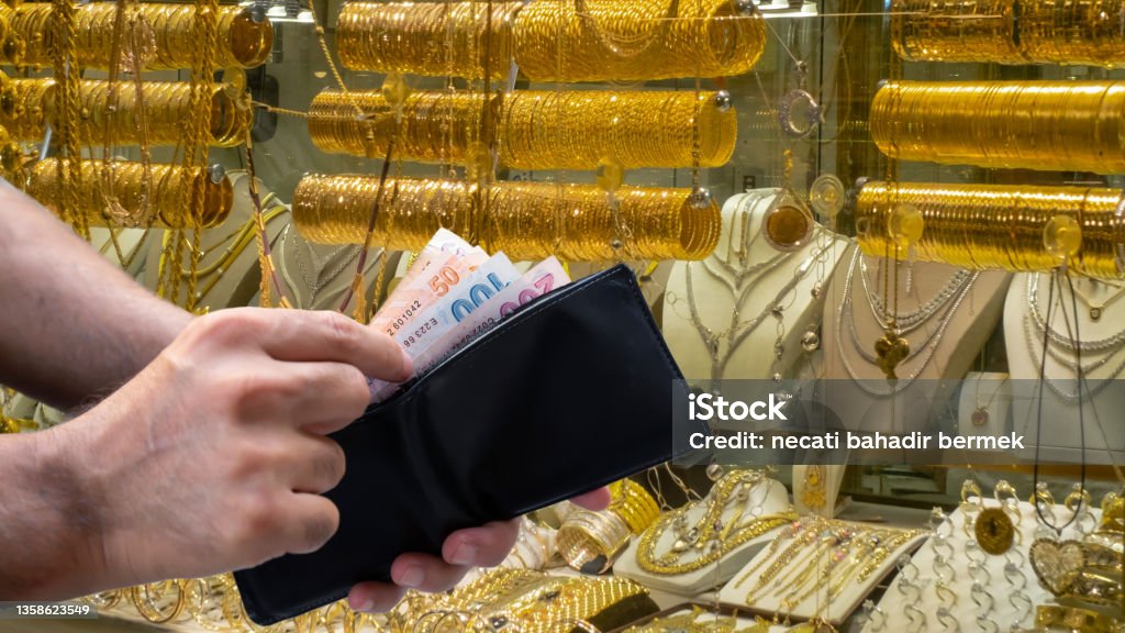 male hand taking money out of wallet male hand taking money out of wallet in jewelery shop Gold - Metal Stock Photo