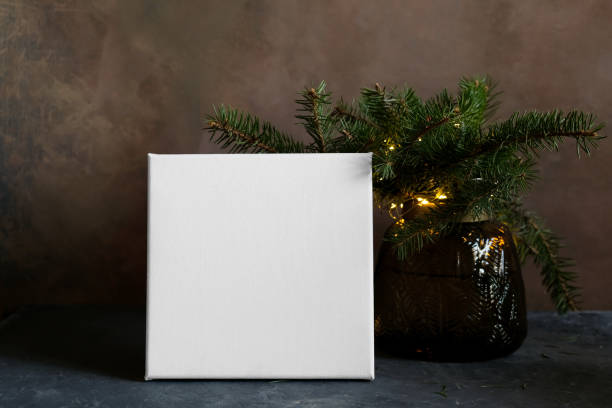 istock Blank canvas and Christmas tree twigs 1358623639