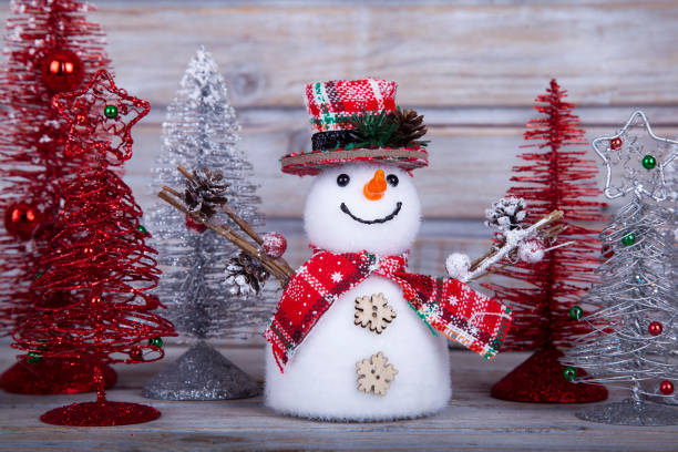 istock Christmas decorative snowman on white rustic wooden background. 1358625653