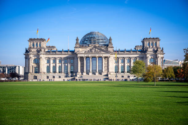 The Bundestag Reichstag building in Berlin The Reichstag Bundestag (German: Reichstagsgebaude) building in Berlin with the German flag. bundestag photos stock pictures, royalty-free photos & images