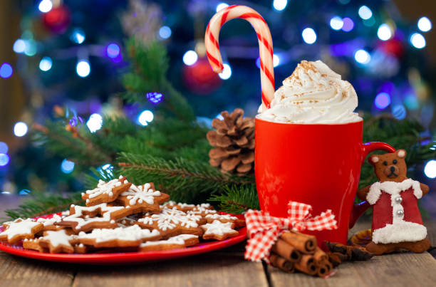 istock Christmas cappuccino and gingerbread cookies infront Christmas tree 1358626132