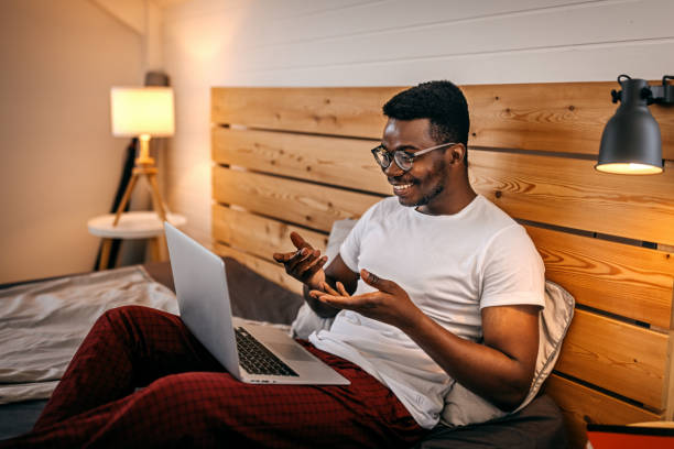 istock Man doing video call in morning using laptop 1358627000