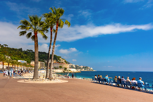 South sidewalk witn blue chairs of Promenade des Anglais in Nice, French Riviera, France