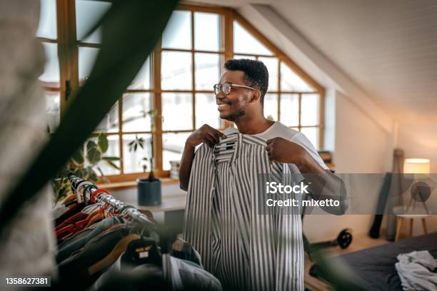 Man Selecting Clothes From Rack At Home Stock Photo - Download Image Now - Closet, Men, Clothing