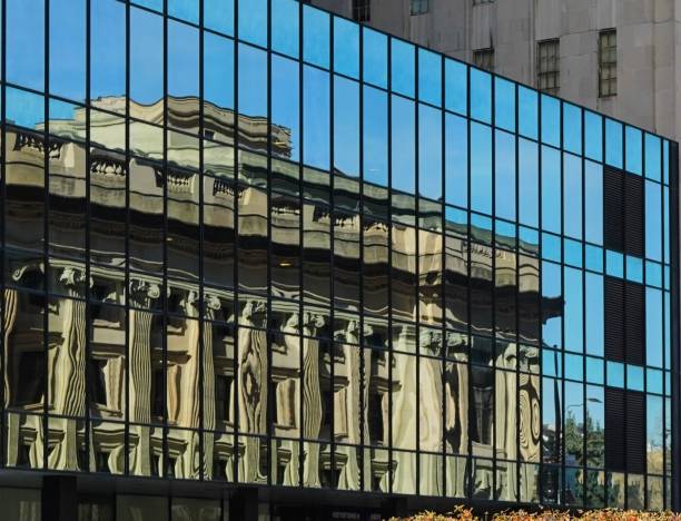 Birch Bayh Federal Building and U.S. Courthouse (and formerly housed the post office) in downtown Indianapolis, Indiana, USA reflected in a mirrored building across the street.  Built in 1902-1905, the building is magnificent architecture.