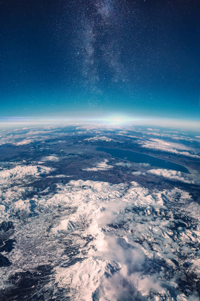 view of stars and milkyway above earth from space - globe earth space high angle view imagens e fotografias de stock