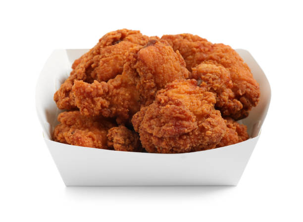istock Tasty deep fried chicken pieces isolated on white 1358630987