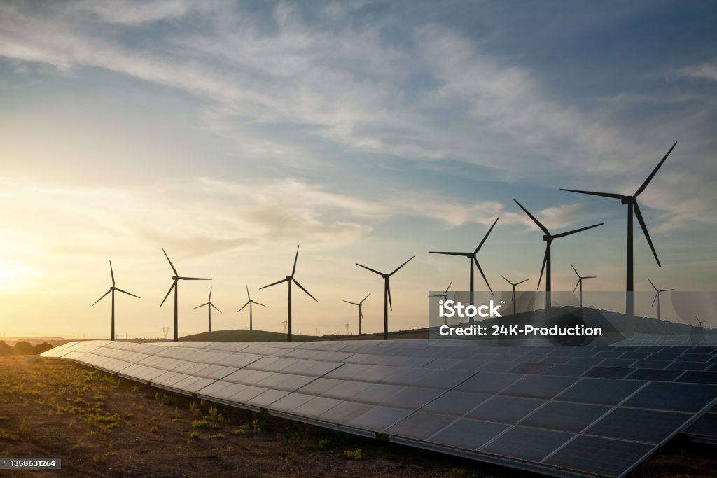 Solar and wind energy farm Solar panels and wind turbines generating renewable energy for green and sustainable future. Renewable Energy Stock Photo