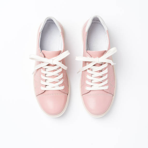 istock Pink trainers on white background. Close up 1358632384