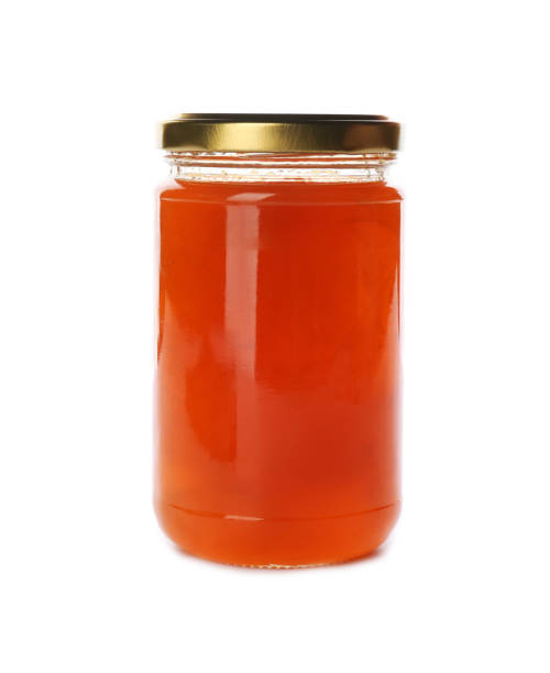 istock Glass jar with peach jam isolated on white. Pickling and preservation 1358632455