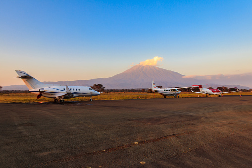 Small propeller airplanes on a background of Meru mountain in Arusha airport, Tanzania
