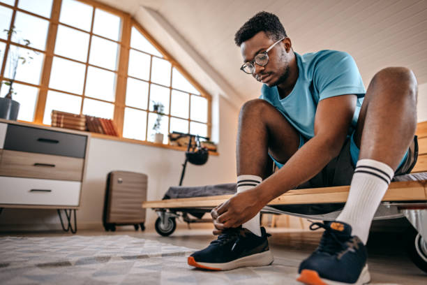 istock Man wearing shoes preparing for workout 1358633586