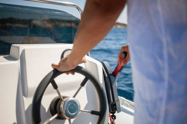 Man driving a boat stock photo