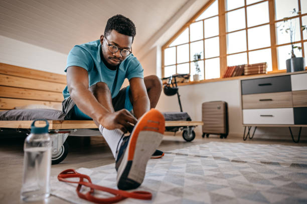 istock Man wearing shoes preparing for workout 1358633625