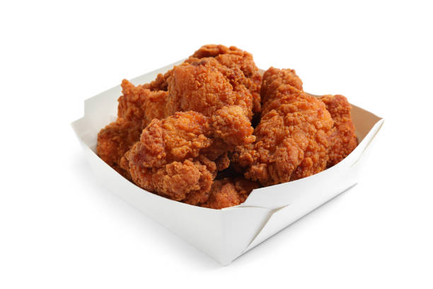 istock Tasty deep fried chicken pieces isolated on white 1358634631