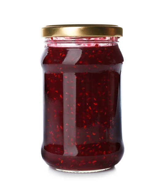 istock Glass jar with raspberry jam isolated on white. Pickling and preservation 1358634812