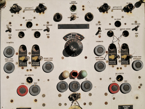 Vintage switch control panel with many buttons in factory manufacturing with Russian labels.