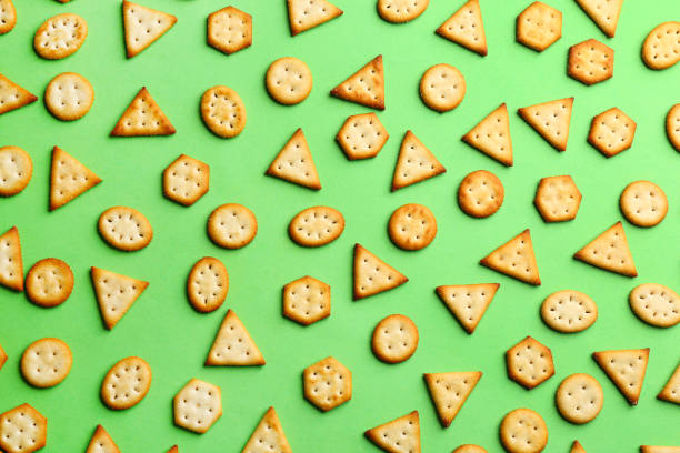 istock Delicious crackers on light green background, flat lay 1358635228