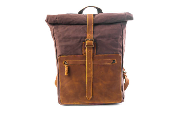 istock Canvas Backpack isolated on white background. Burgundy with brown bag. Hand made backpack for travelers. 1358635280